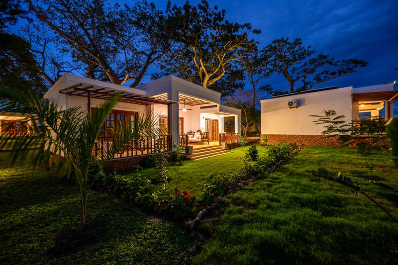 Kasa Pomboo cottage exterior at dusk with solar panels