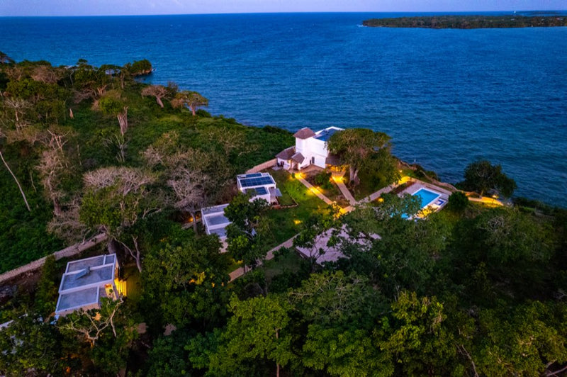 Twilight aerial view of Kasa Pomboo's clifftop property
